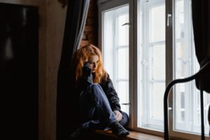 Image of girl sitting by window
